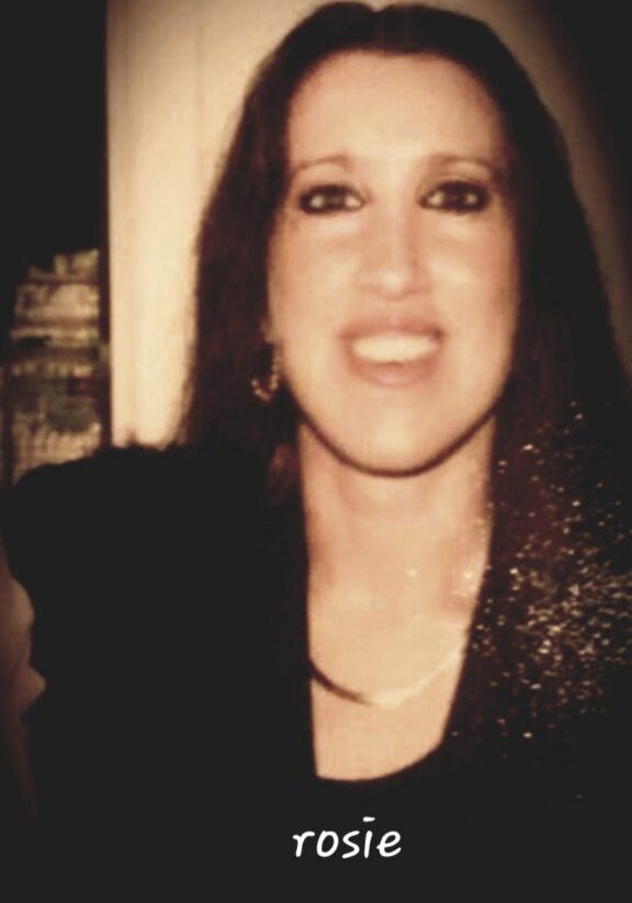 Smiling woman portrait with dark hair and necklace